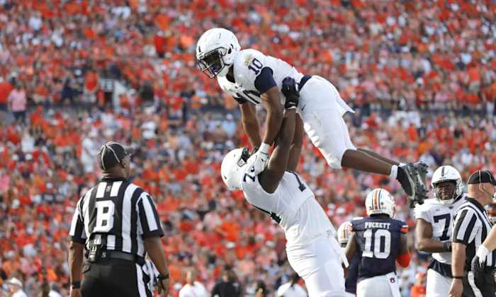 Sep 17, 2022; Auburn, Alabama, USA; Penn State Nittany Lions running back Nicholas Singleton (10) celebrates with offensive lineman Olumuyiwa Fashanu (74) after scoring a touchdown against the Auburn Tigers during the third quarter at Jordan-Hare Stadium.